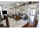Bright living room with vaulted ceilings, fireplace, and a cozy sectional sofa, creating a welcoming and comfortable atmosphere at 10688 Ashview Dr, Fishers, IN 46038