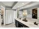 Bathroom featuring double sinks, white countertops, and a shower/tub combo with a white curtain at 10764 Gettysburg Pl, Carmel, IN 46032