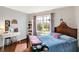 Charming bedroom with colorful curtains, a cozy bed, and a decorative rainbow shelf at 10764 Gettysburg Pl, Carmel, IN 46032
