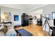 Open living room with hardwood floors and a telescope next to the dining room at 10764 Gettysburg Pl, Carmel, IN 46032