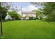 Large grassy backyard with a view of the home and an enclosed screened in porch at 11141 Saybrook Ct, Fishers, IN 46037