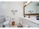 Bright bathroom with double sink vanity, wood-framed mirror, and modern fixtures at 11141 Saybrook Ct, Fishers, IN 46037