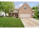 Charming two-story home with brick and vinyl siding, manicured lawn, and covered front porch at 11141 Saybrook Ct, Fishers, IN 46037