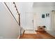 Bright foyer featuring hardwood floors, a staircase, and decoratively-placed shoe storage at 11141 Saybrook Ct, Fishers, IN 46037