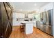 Bright kitchen with white cabinets, stainless steel appliances, wood floors, and a center island at 11141 Saybrook Ct, Fishers, IN 46037