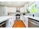 Well-lit kitchen featuring white cabinets, a center island, stainless steel appliances, and stylish backsplash at 11141 Saybrook Ct, Fishers, IN 46037