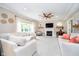 Bright living room with white couches, fireplace, ceiling fan and lots of natural light at 11141 Saybrook Ct, Fishers, IN 46037