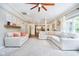 Open-concept living room featuring neutral tones, plush seating, and seamless flow to the kitchen at 11141 Saybrook Ct, Fishers, IN 46037