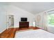 Spacious main bedroom with a vaulted ceiling, wood floors, and a modern dresser at 11141 Saybrook Ct, Fishers, IN 46037