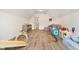Spacious playroom in finished attic with hardwood floors, plentiful light, and toys at 11141 Saybrook Ct, Fishers, IN 46037