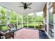 Relaxing screened porch with wicker furniture and views of the landscaped backyard at 11141 Saybrook Ct, Fishers, IN 46037