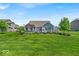 Spacious backyard features a patio with a pergola and ample green space perfect for outdoor activities at 11438 Montoya Dr, Zionsville, IN 46077