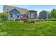 Large backyard featuring a patio, firepit, built-in grill, pergola and mature landscaping at 11438 Montoya Dr, Zionsville, IN 46077