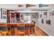 Finished basement bar featuring a TV, bar stools and custom wood features for entertaining at 11438 Montoya Dr, Zionsville, IN 46077