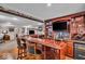 Basement bar featuring a TV, bar stools, and custom wood features, ideal for entertaining guests at 11438 Montoya Dr, Zionsville, IN 46077