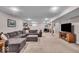 Finished basement features a sectional sofa, TV and neutral carpeting for a comfortable space at 11438 Montoya Dr, Zionsville, IN 46077