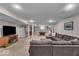 Finished basement features a large sectional sofa, TV, pool table, and neutral carpeting at 11438 Montoya Dr, Zionsville, IN 46077