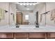 Bathroom featuring double sinks, walk-in shower, and framed mirror at 11438 Montoya Dr, Zionsville, IN 46077