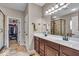 Bathroom featuring double sinks, walk-in shower, and walk-in closet at 11438 Montoya Dr, Zionsville, IN 46077