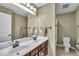 Bathroom featuring a double vanity with large mirror, shower and toilet, providing ample space at 11438 Montoya Dr, Zionsville, IN 46077