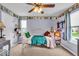 Bedroom with white bed frame, decorated with personal touches, is well-lit by two windows at 11438 Montoya Dr, Zionsville, IN 46077