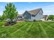Beautiful blue home with a manicured lawn and inviting back deck for outdoor relaxation and entertainment at 11438 Montoya Dr, Zionsville, IN 46077