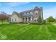 Inviting home with a well-kept lawn and a mix of stone and siding exterior at 11438 Montoya Dr, Zionsville, IN 46077