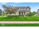 Charming two-story home featuring a well-manicured lawn and stone facade at 11438 Montoya Dr, Zionsville, IN 46077