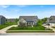 Beautiful two-story home with manicured lawn, stone accents and covered entry at 11438 Montoya Dr, Zionsville, IN 46077