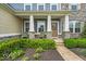 Close up of a welcoming front porch with seating and decorative stone pillars at 11438 Montoya Dr, Zionsville, IN 46077