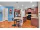 Modern kitchen with stainless steel appliances, granite counters, and hardwood floors at 11438 Montoya Dr, Zionsville, IN 46077