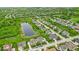 Neighborhood view showcasing the community's pond, tree-lined streets, and varied home styles at 11438 Montoya Dr, Zionsville, IN 46077