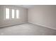 Bright bedroom featuring neutral walls, plush carpeting, and a large window offering natural light at 1151 Canterbury Ct # D, Indianapolis, IN 46260
