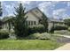 Charming home with lush landscaping, mature trees, and a well-manicured lawn at 1151 Canterbury Ct # D, Indianapolis, IN 46260