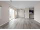 Spacious living room featuring a sliding glass door to the balcony, neutral paint and wood floors at 1151 Canterbury Ct # D, Indianapolis, IN 46260