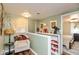 This landing features an armchair, wall art, decor, and a view of the bedroom at 116 High St, Brooklyn, IN 46111
