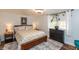 This cozy bedroom features natural light, a comfortable bed, and wooden floors at 116 High St, Brooklyn, IN 46111