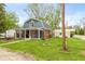 Charming home featuring a screened-in porch, well-maintained lawn, and convenient detached garage for parking at 116 High St, Brooklyn, IN 46111