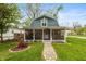Charming home featuring a welcoming screened-in porch and a beautifully landscaped front yard with a stone walkway at 116 High St, Brooklyn, IN 46111