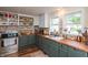 Well-lit kitchen with custom shelving, wood countertops, and ample cabinet space for organized storage at 116 High St, Brooklyn, IN 46111