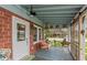 Relaxing screened porch with a cozy swing, comfortable seating, and a view of the surrounding neighborhood at 116 High St, Brooklyn, IN 46111
