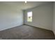 Bedroom with plush carpet and single window overlooking the front yard at 1216 Mcbride St, Greenfield, IN 46140