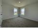 Well-lit bedroom features plush carpet and two windows providing natural light at 1216 Mcbride St, Greenfield, IN 46140