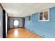 Bedroom with wood floors, blue walls, large windows and window AC unit at 126 Brunswick Dr, Greenwood, IN 46143