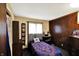 This bedroom is equipped with wood paneled walls and a large window for ample natural lighting at 126 Brunswick Dr, Greenwood, IN 46143