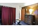 Wood paneled bedroom featuring closet with curtain and exercise equipment at 126 Brunswick Dr, Greenwood, IN 46143