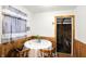 Dining area with wood paneling, seating for four, view to adjacent room at 126 Brunswick Dr, Greenwood, IN 46143