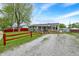 Exterior shot of the home, highlighting the yard, ramp and gravel driveway at 126 Brunswick Dr, Greenwood, IN 46143