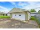 View of the garage featuring vinyl siding and a large door at 126 Brunswick Dr, Greenwood, IN 46143