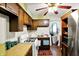 Traditional kitchen featuring wood cabinets, gas range, ceiling fan and stainless steel refrigerator at 126 Brunswick Dr, Greenwood, IN 46143